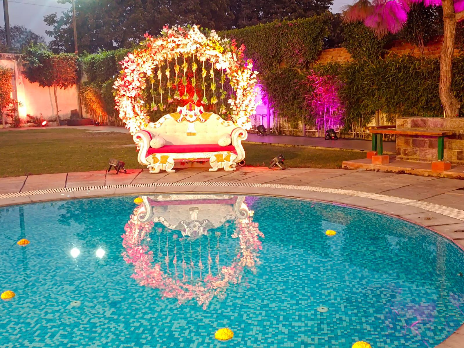 Floral throne beside the pool at night